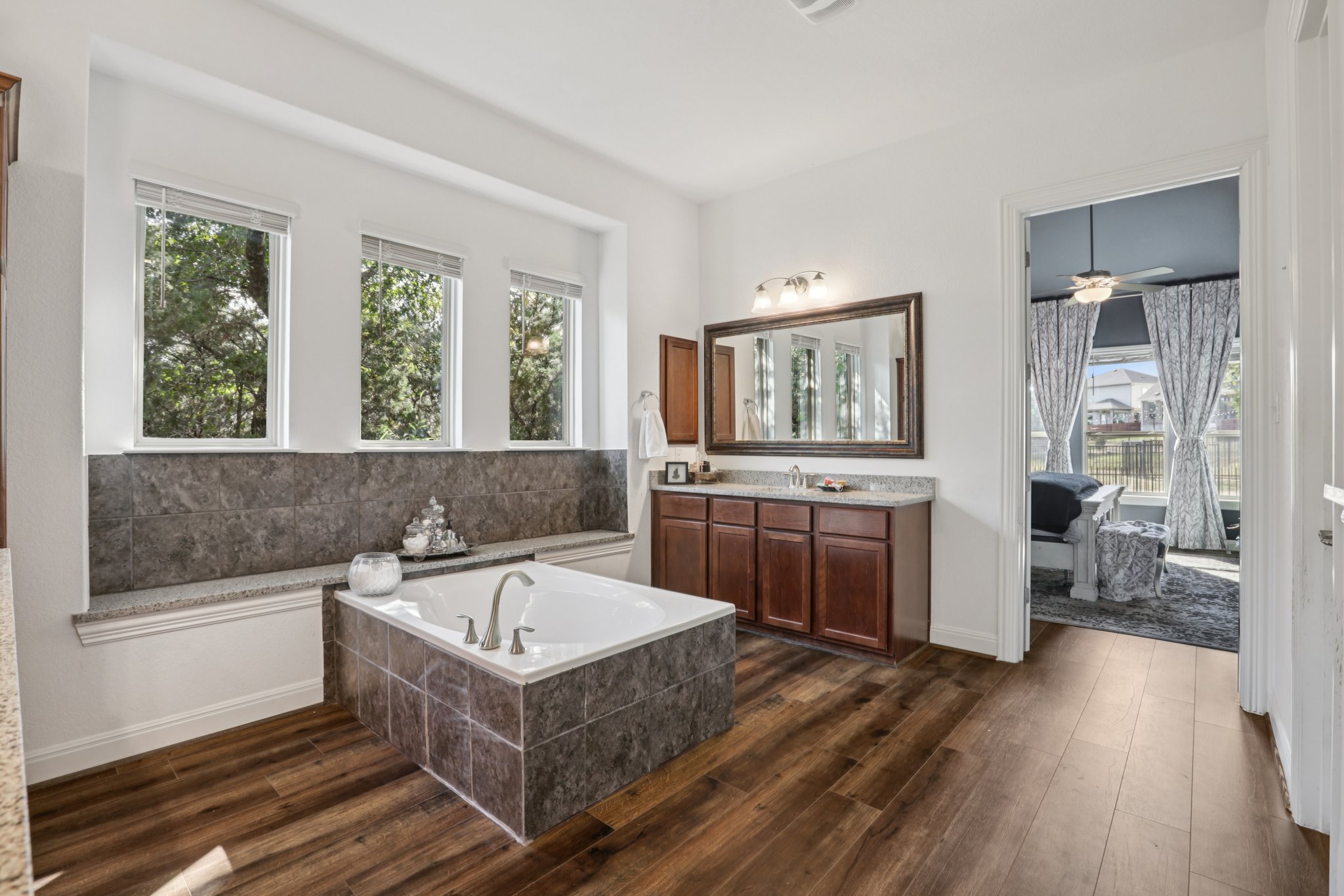 210 Barton Run Drive Georgetown, TX 78628 - Photo 34 of 40 a bathroom with a tub a sink and a large window