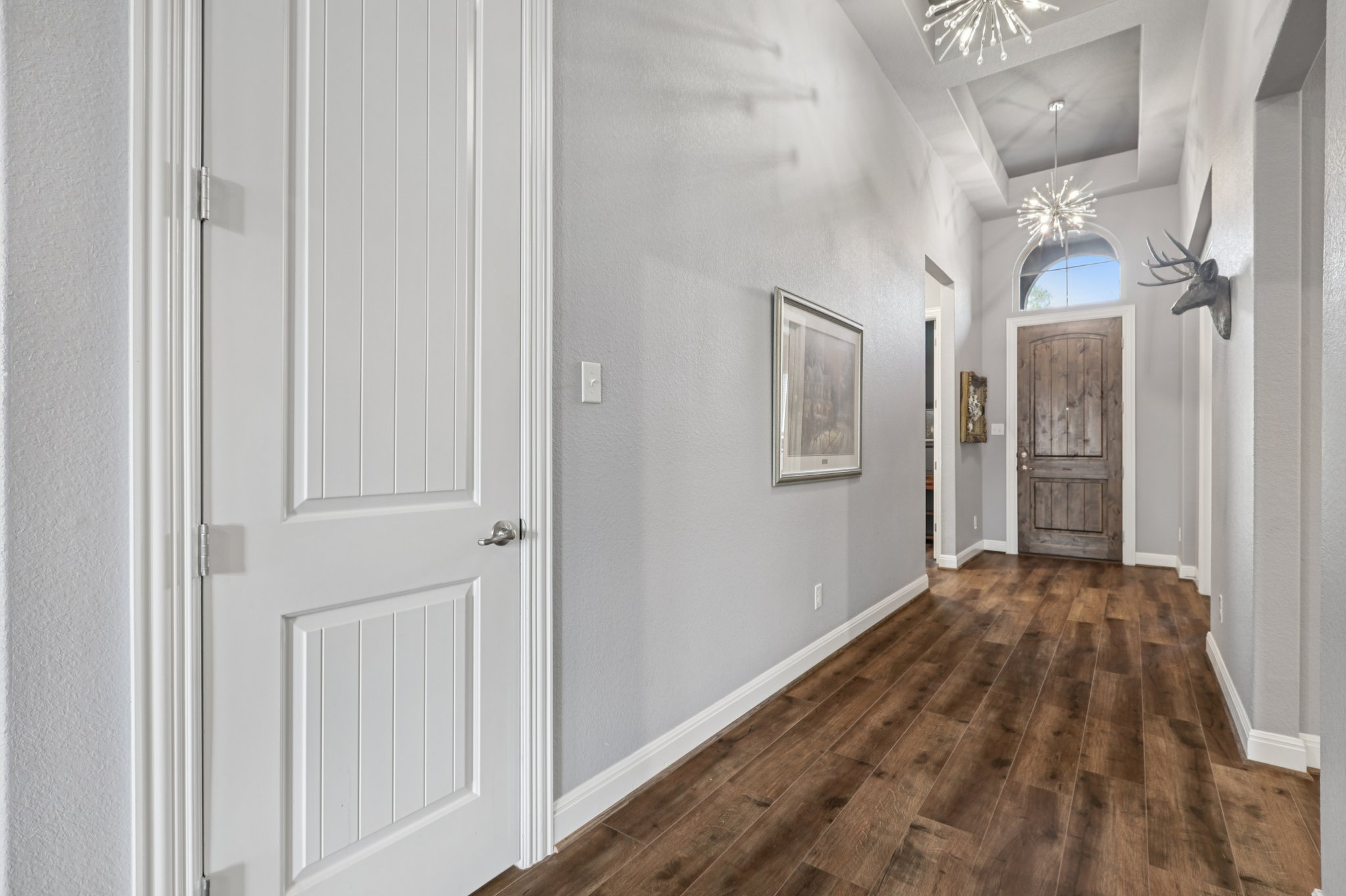 210 Barton Run Drive Georgetown, TX 78628 - Photo 4 of 40 a view of a hallway with wooden floor and a bathroom