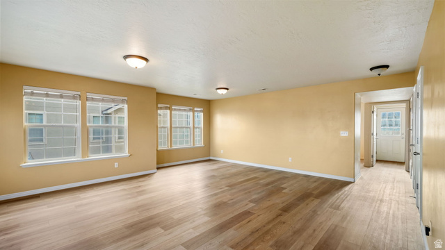 983 South 1850th Street West Springville, UT 84663 - Photo 2 of 30 Spacious room featuring wood-finish flooring and multiple transom windows