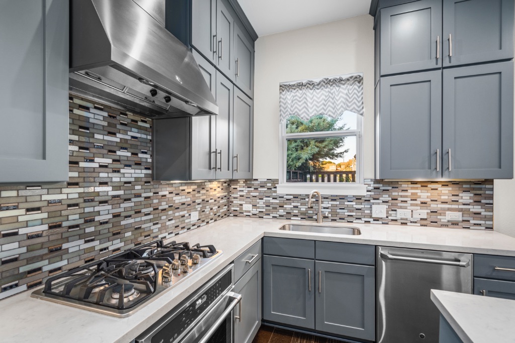 1004 Banyon Street Austin, TX 78757 - Photo 11 of 33 a kitchen with sink stove and cabinets