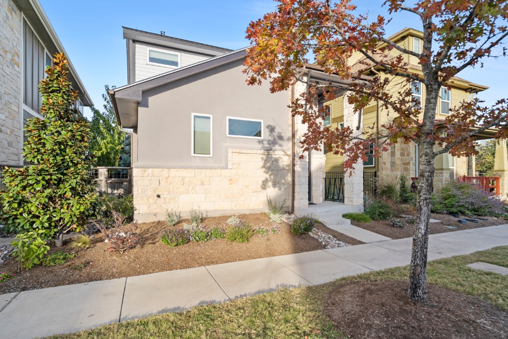 1004 Banyon Street Austin, TX 78757 - Photo 3 of 33 a front view of a house with a yard and tree s