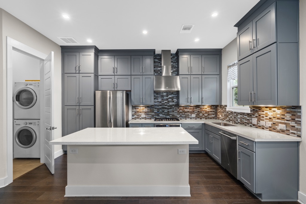 1004 Banyon Street Austin, TX 78757 - Photo 9 of 33 a kitchen with kitchen island sink stove and refrigerator