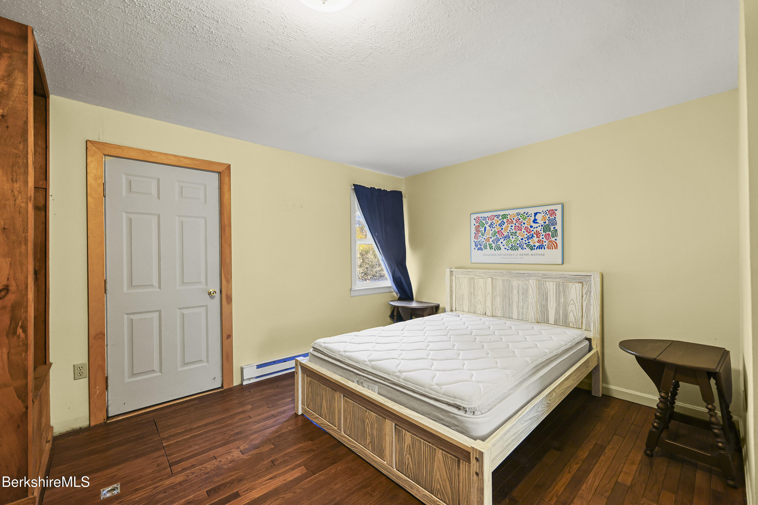88 East Windsor Road Peru, MA 01235 - Photo 14 of 47 a bedroom with a bed and a table in it