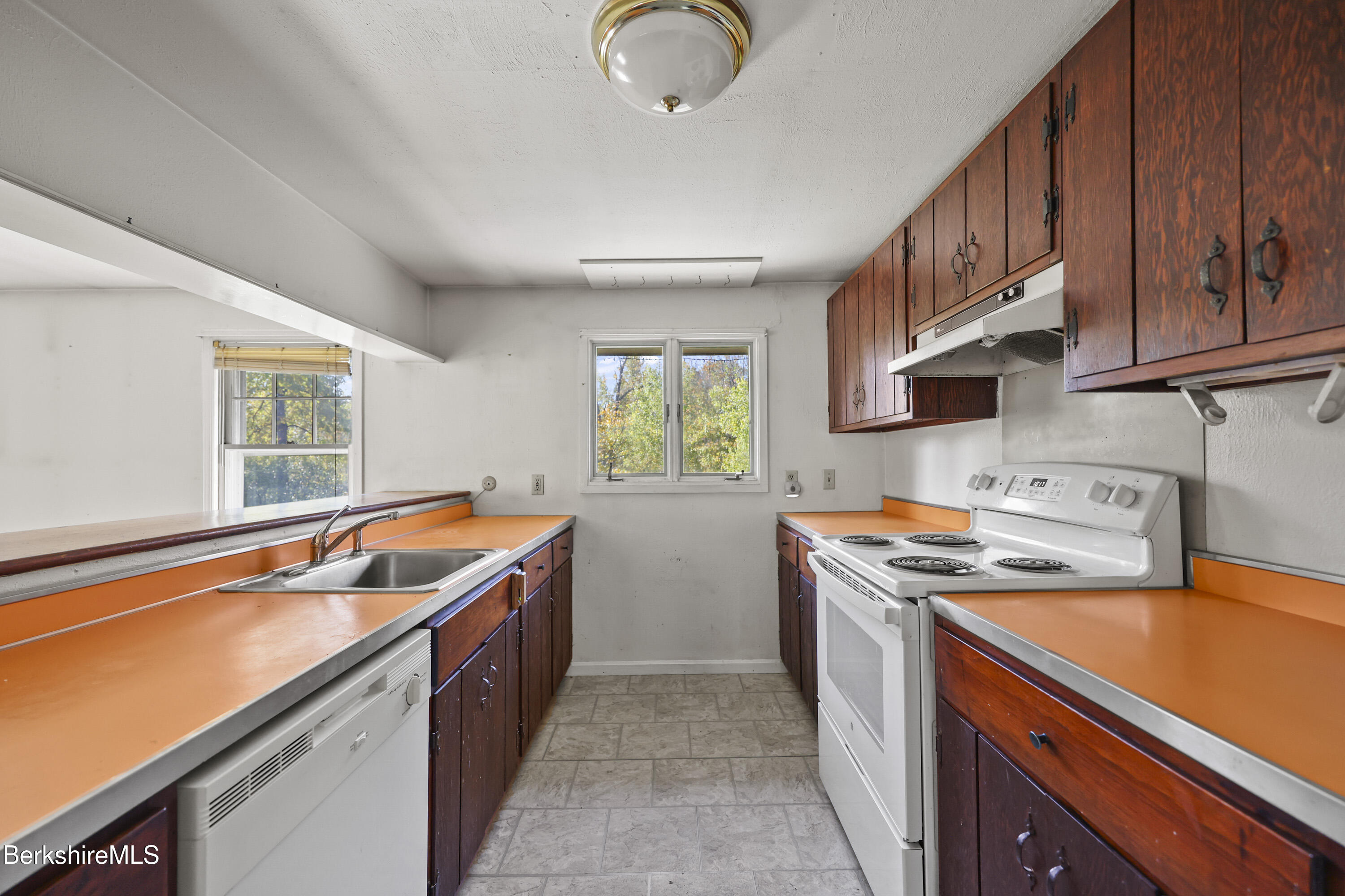88 East Windsor Road Peru, MA 01235 - Photo 31 of 47 a kitchen with stainless steel appliances granite countertop a sink a stove and a refrigerator