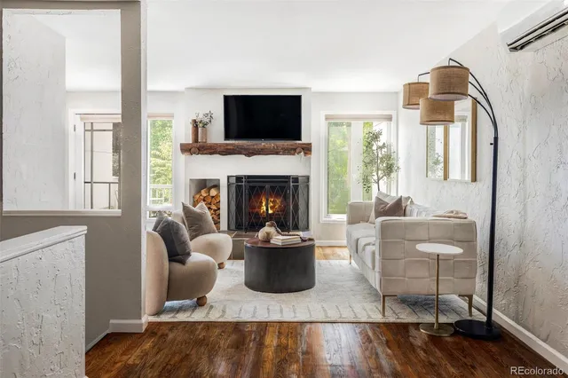 a living room with furniture a flat screen tv and a fireplace