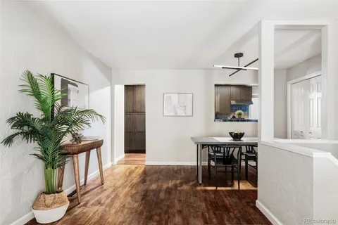 a view of a dining room with furniture and a chandelier