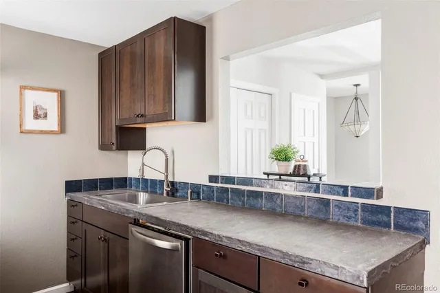 a kitchen with granite countertop a sink and a cabinets
