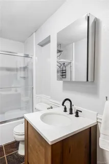 a bathroom with a sink toilet and shower