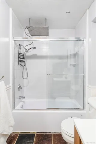 a bathroom with a shower and a toilet