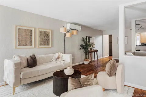a living room with furniture and wooden floor