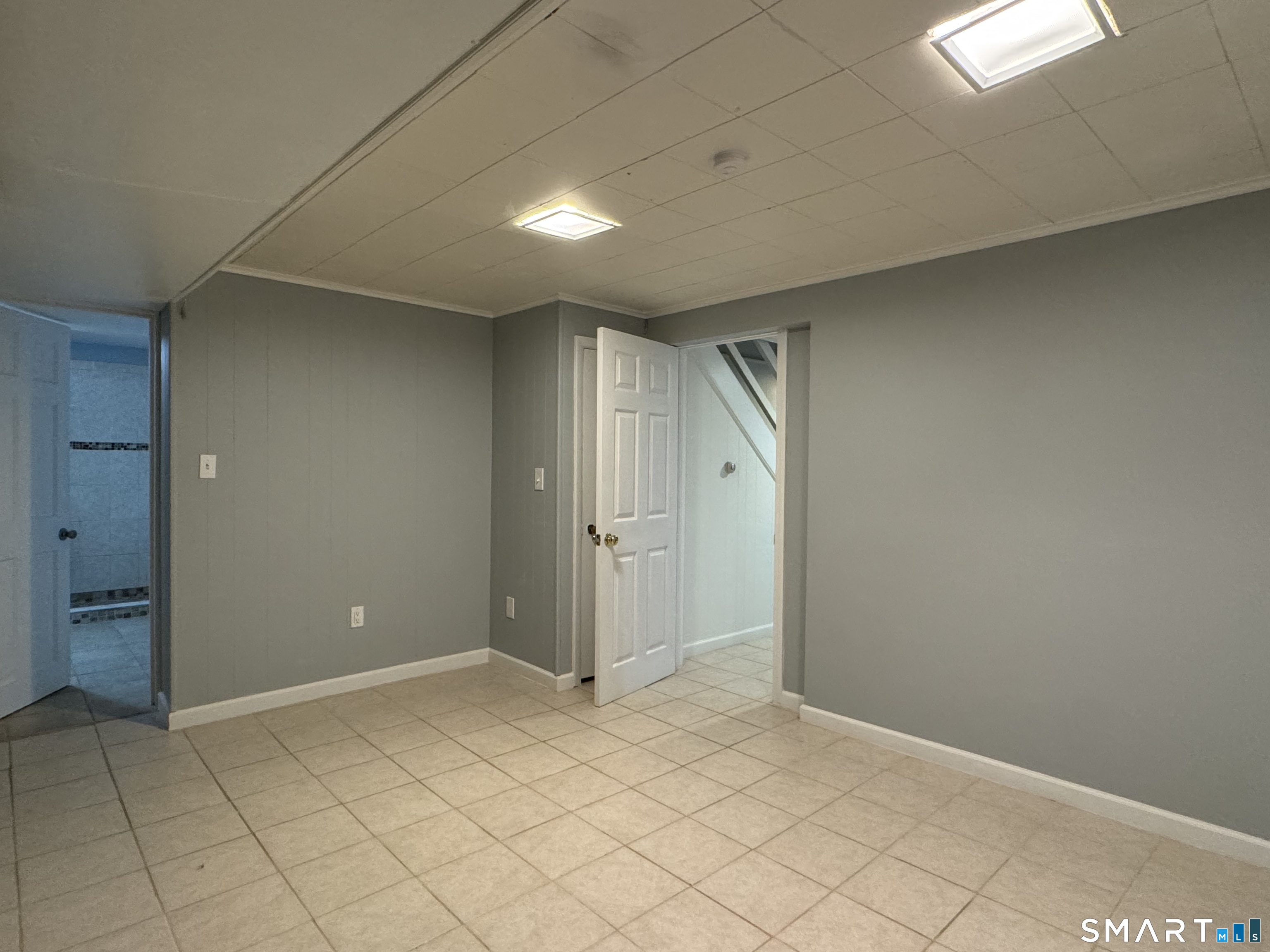 118 Pullen Avenue Watertown, CT 06779 - Photo 3 of 8 an empty room with white walls and tiles