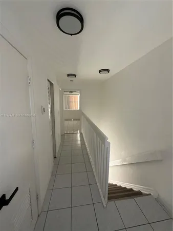 a view of a room with wooden floor and windows