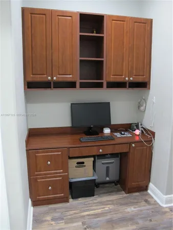 a living room with a table chairs and a chandelier