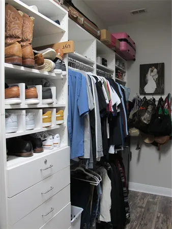a living room with furniture kitchen area and a window