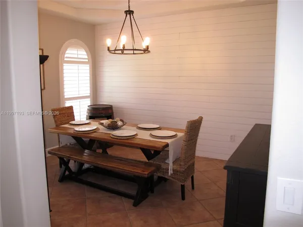 a kitchen with stainless steel appliances granite countertop a refrigerator stove top oven and sink