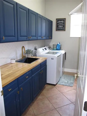 a dining room with furniture a chandelier and glass door