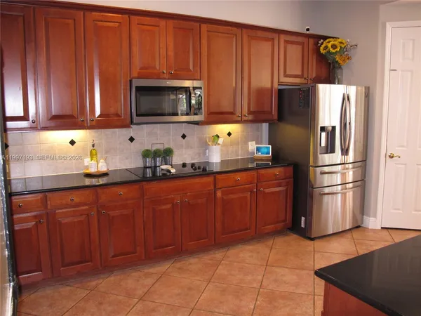 a bedroom with a bed and a flat tv screen on the dresser