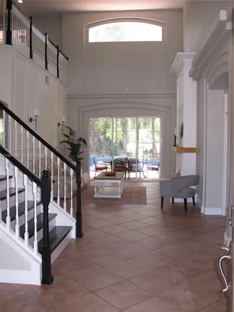 a living room with furniture and a floor to ceiling window