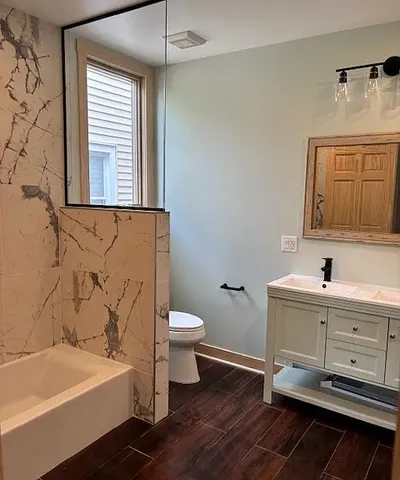 a bathroom with a sink a toilet and a bathtub