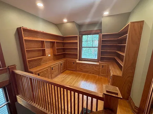a view of walk in closet with window and wooden floor