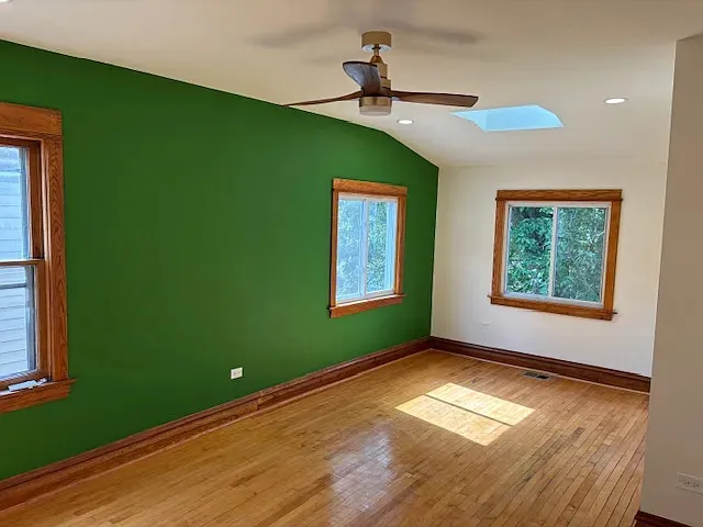 a view of empty room with window and fan