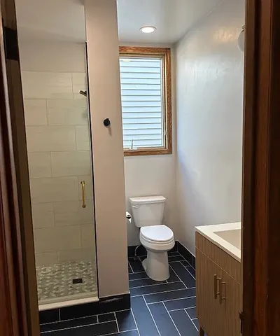 a bathroom with a toilet a sink and a shower