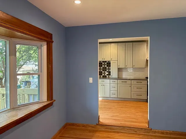 a room with window and cabinets