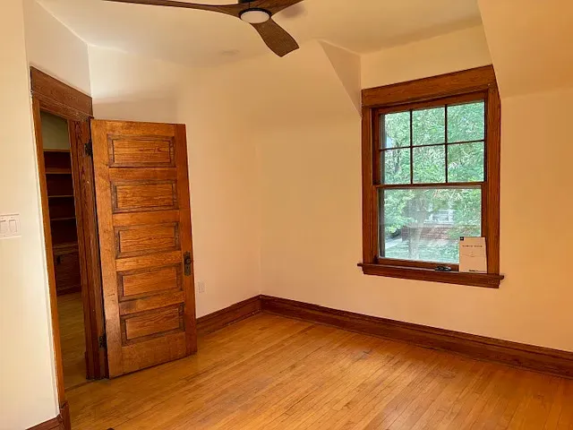wooden floor in an empty room with a window
