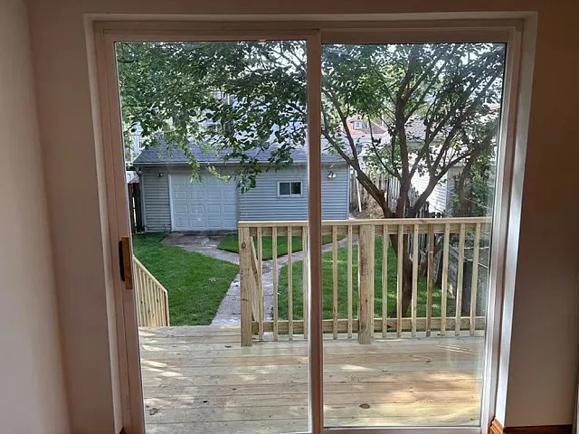 a view of a house with a small yard next to a yard
