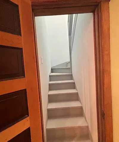 a view of staircase with white walls and a window