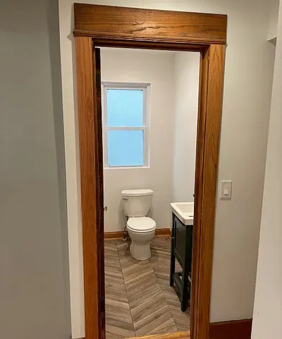 a bathroom with a toilet and a mirror
