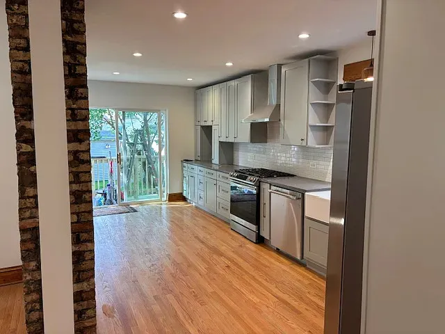 a kitchen with stainless steel appliances granite countertop a stove and a refrigerator