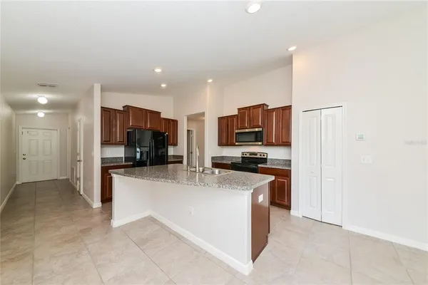a kitchen with stainless steel appliances a refrigerator sink and microwave