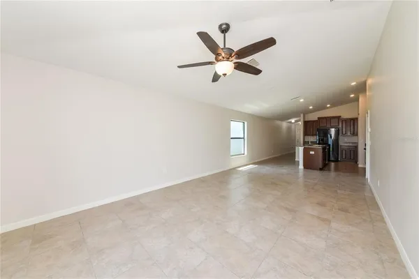 a view of a livingroom with a ceiling fan and window