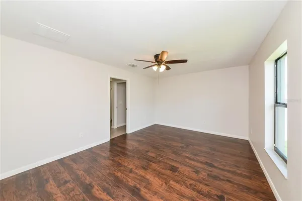 a view of a room with wooden floor closet and windows
