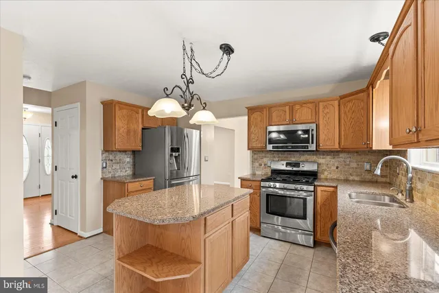 a kitchen with a sink stove and microwave