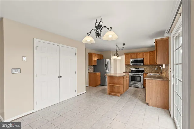 an empty room with windows and fireplace