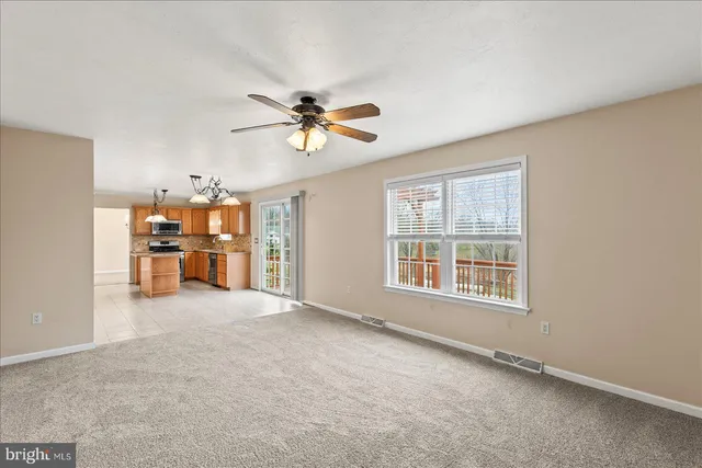 a view of an empty room with chandelier and chandelier