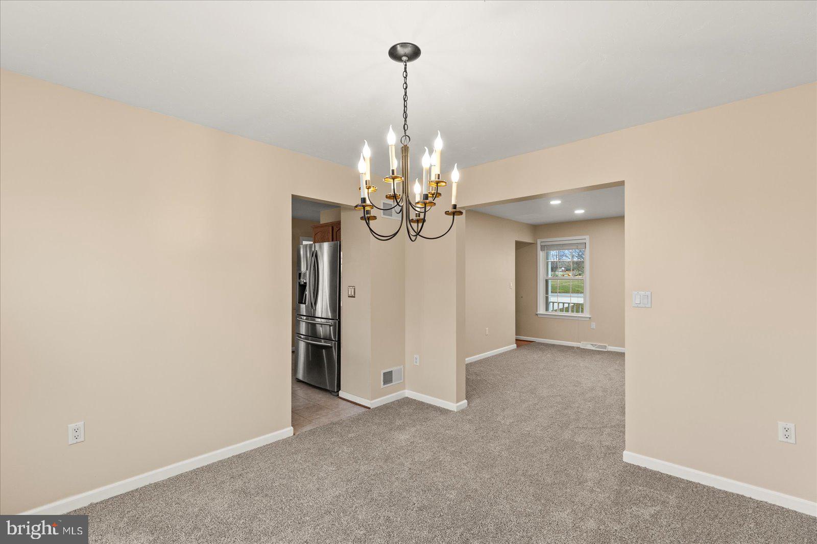 6475 Pamadeva Road Hanover, PA 17331 - Photo 16 of 47 a view of an empty room with chandelier and chandelier
