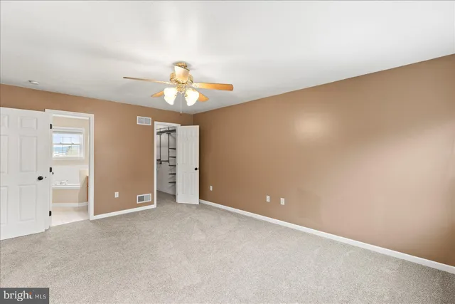 a bathroom with a tub sink shower and mirror