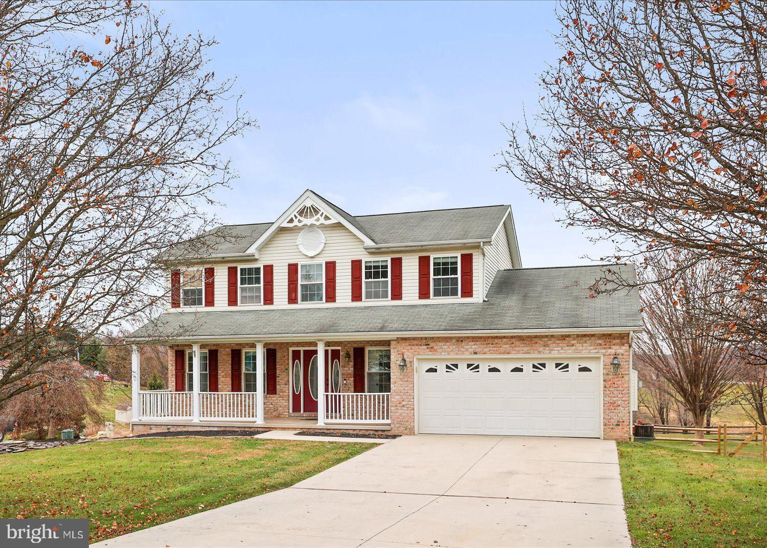 6475 Pamadeva Road Hanover, PA 17331 - Photo 2 of 47 a front view of a house with a garden and trees