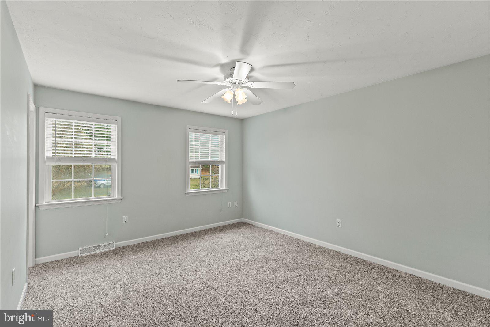 6475 Pamadeva Road Hanover, PA 17331 - Photo 22 of 47 an empty room with chandelier fan and windows