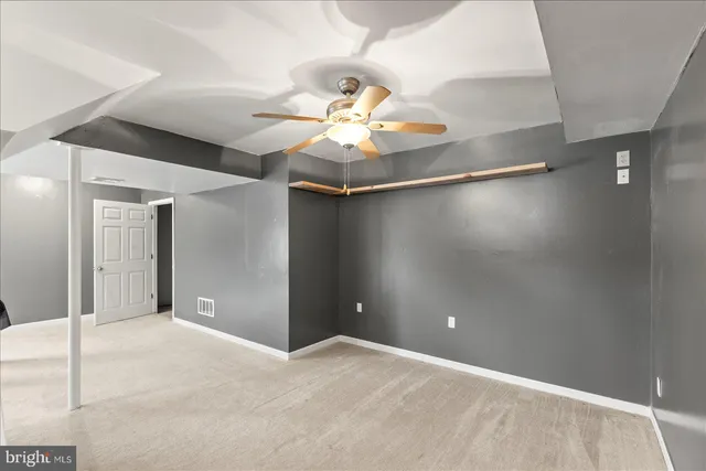 a room with a chandelier and a flat screen tv