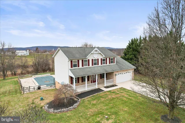 a aerial view of a house with yard and balcony