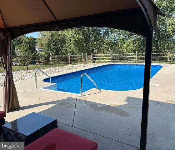 a view of a swimming pool with a patio