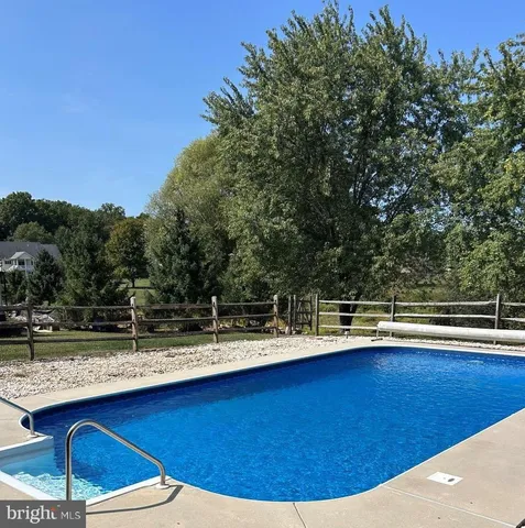a view of a swimming pool with lounge chairs