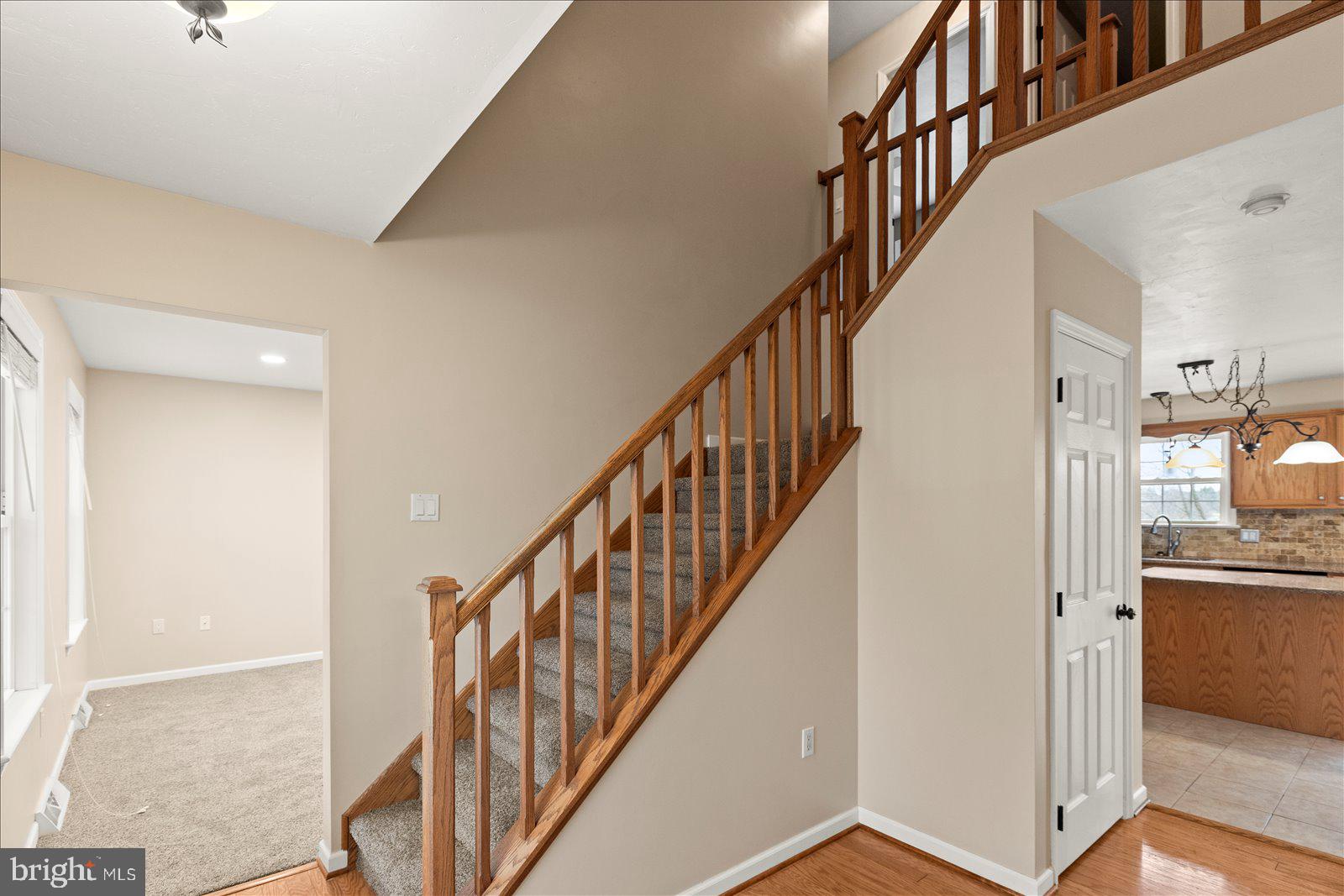 6475 Pamadeva Road Hanover, PA 17331 - Photo 7 of 47 a view of staircase with wooden floor and a chandelier