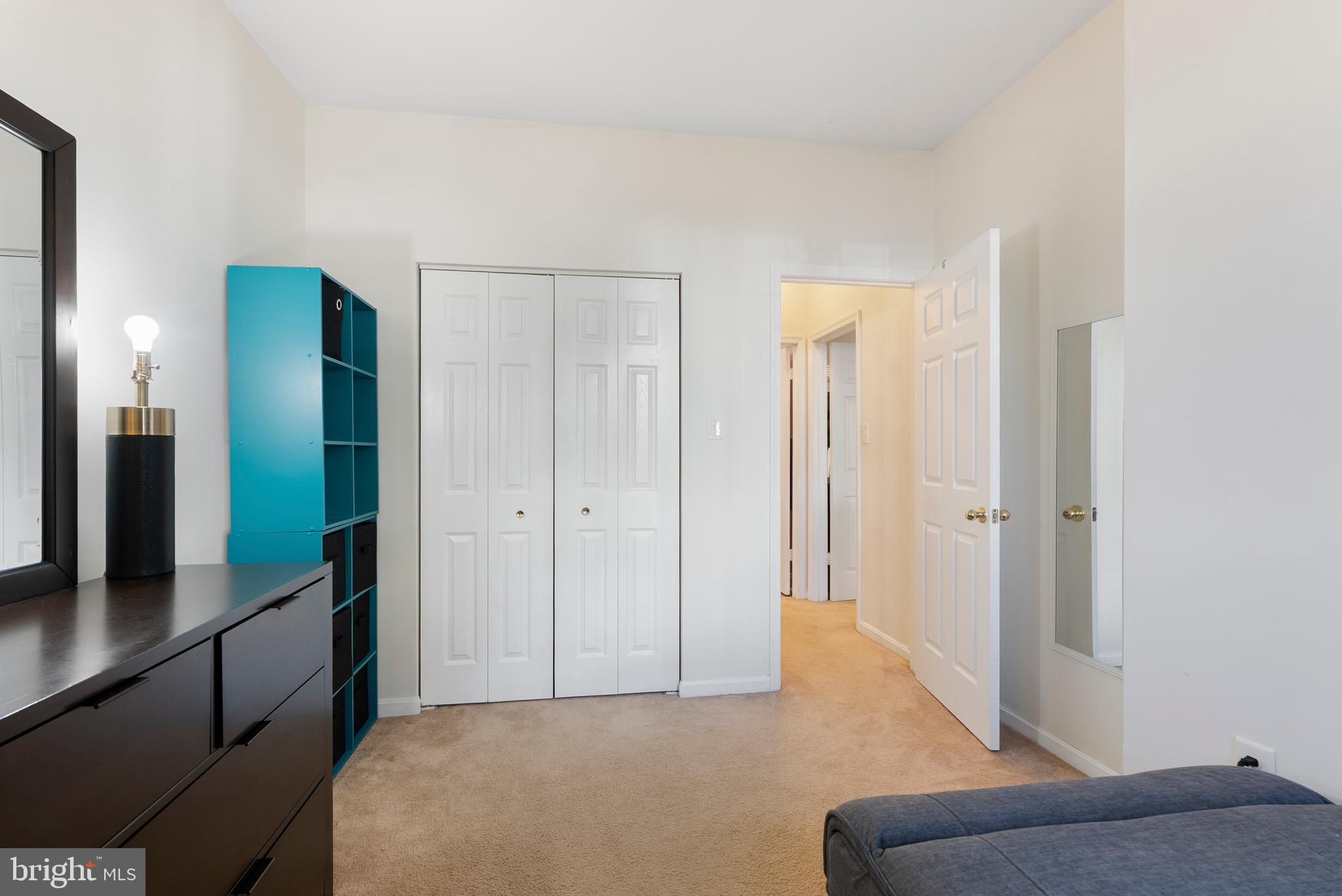 606 Moonglow Road, Unit 103 Odenton, MD 21113 - Photo 13 of 15 a living room with a bed and a dresser