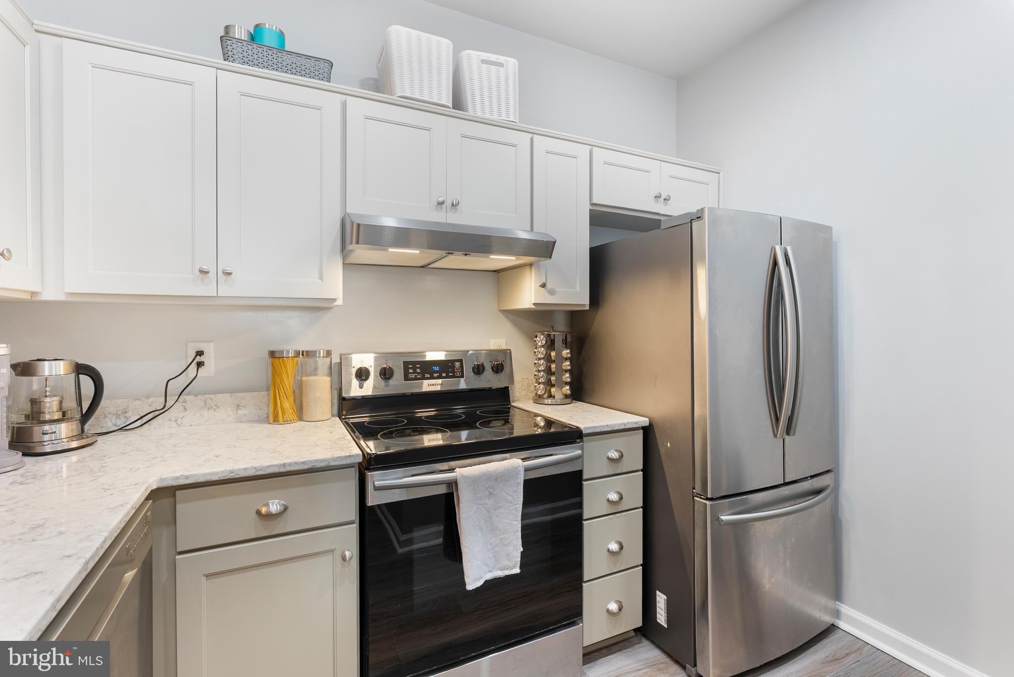 606 Moonglow Road, Unit 103 Odenton, MD 21113 - Photo 8 of 15 a kitchen with stainless steel appliances white cabinets and a refrigerator