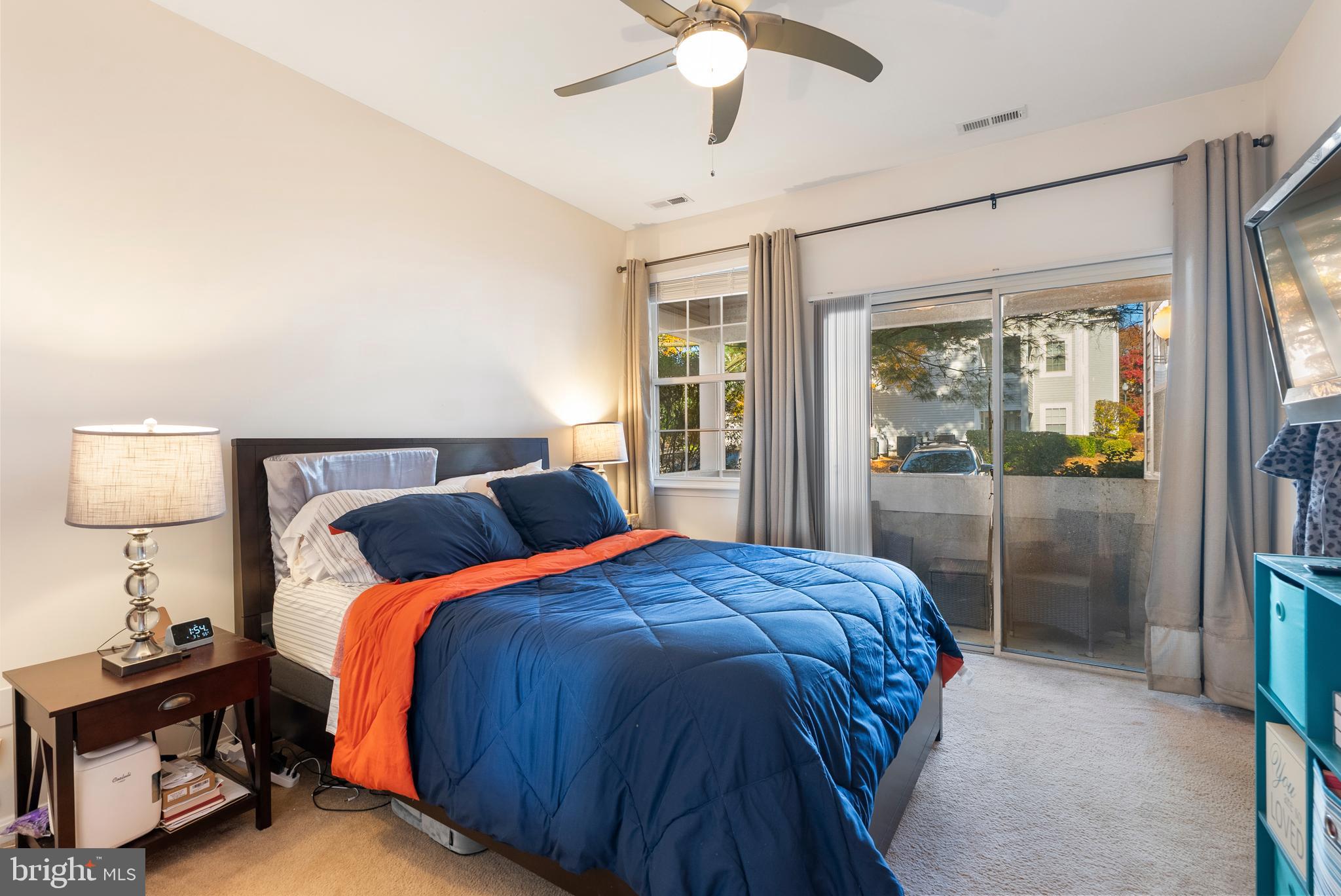 606 Moonglow Road, Unit 103 Odenton, MD 21113 - Photo 10 of 15 a bedroom with a bed and a lamp